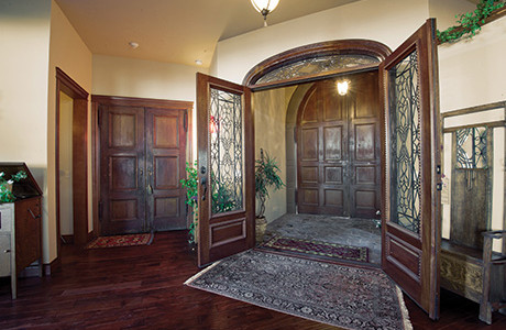 This eclectic styled home harbors unique features on every level.  An elevator connects the three levels of the 7500 sq ft. residence.  Antiques are built in throughout the home, from the 150 year old monastery doors to the bank teller window that over looks the kitchen from the upper level, each piece adds a new bit of character to this home feel. 